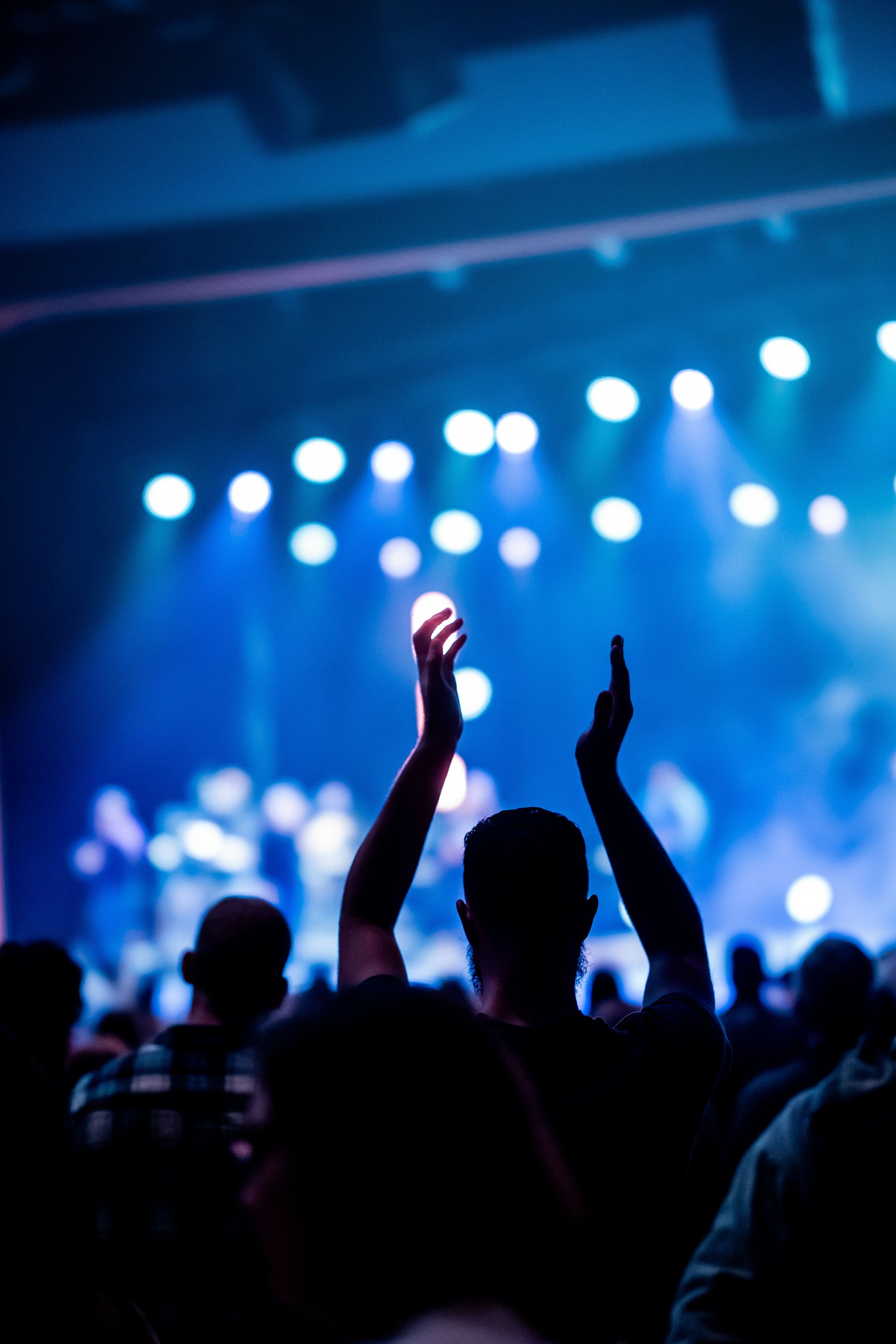 Concert crowd with hands raised